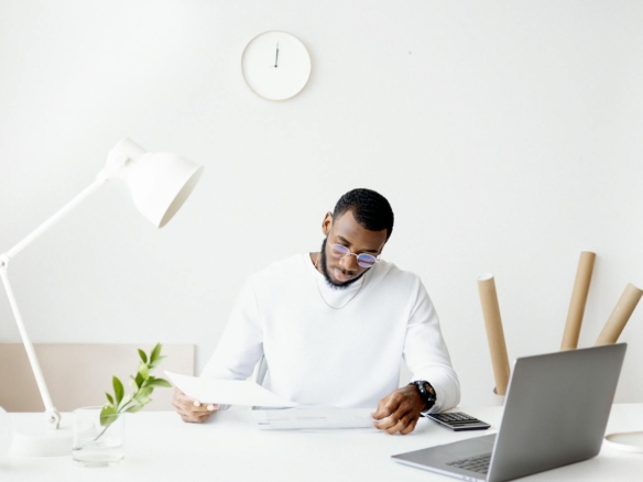 A property owner reviewing rental paperwork at a desk while deciding whether to hire a property manager in Vancouver
