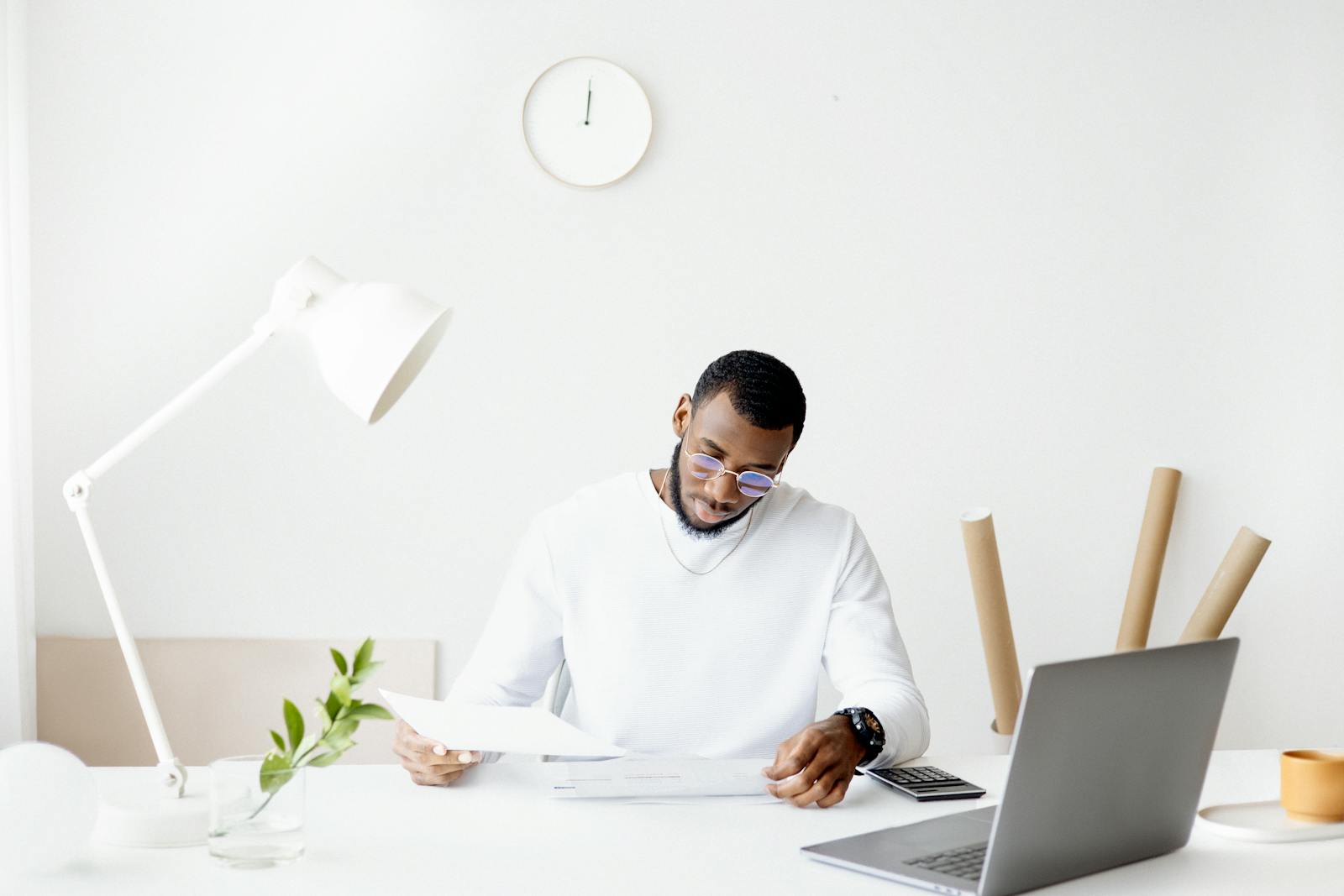 A property owner reviewing rental paperwork at a desk while deciding whether to hire a property manager in Vancouver